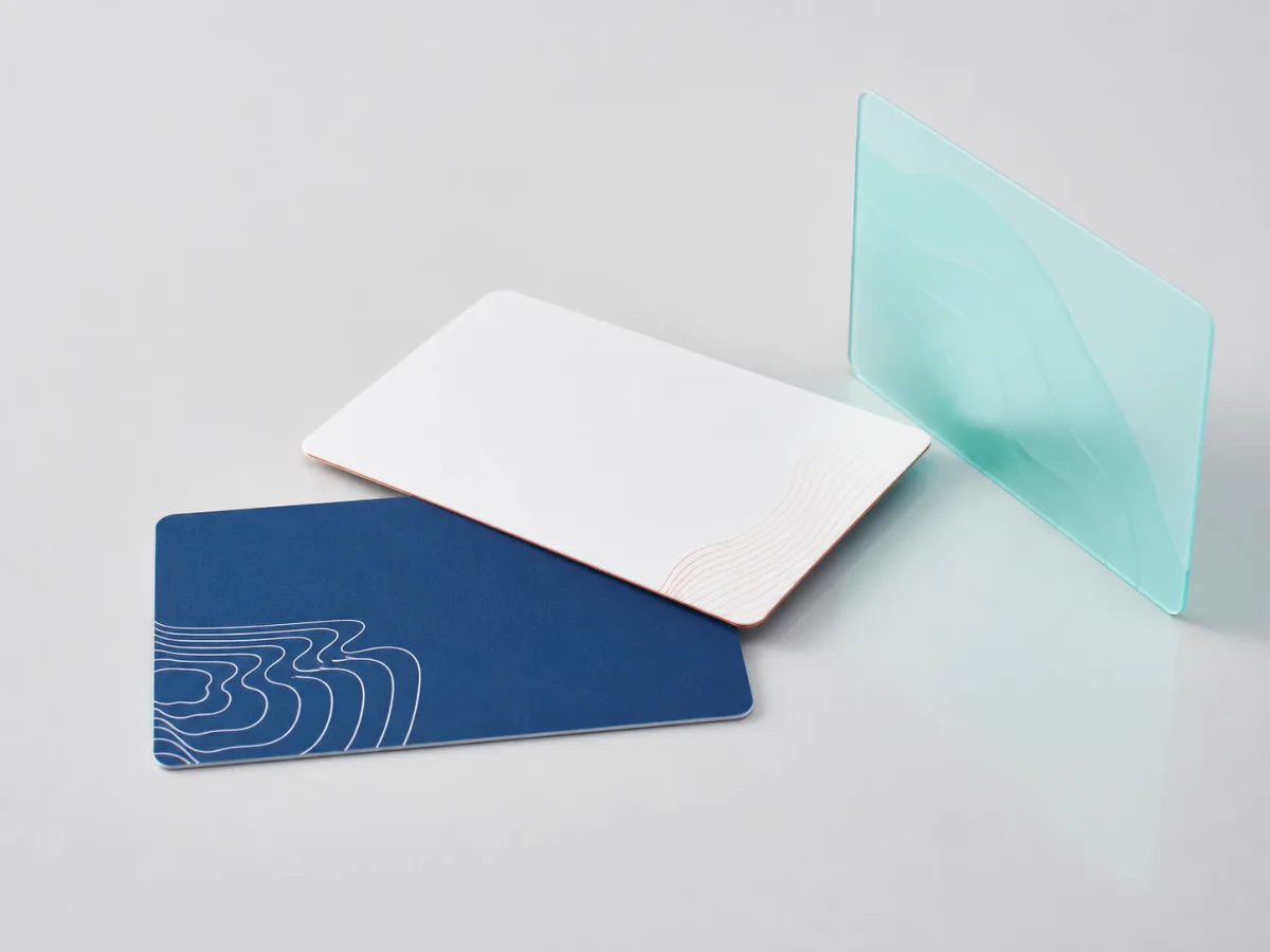Three original thin RFID hotel key card designs on a studio surface