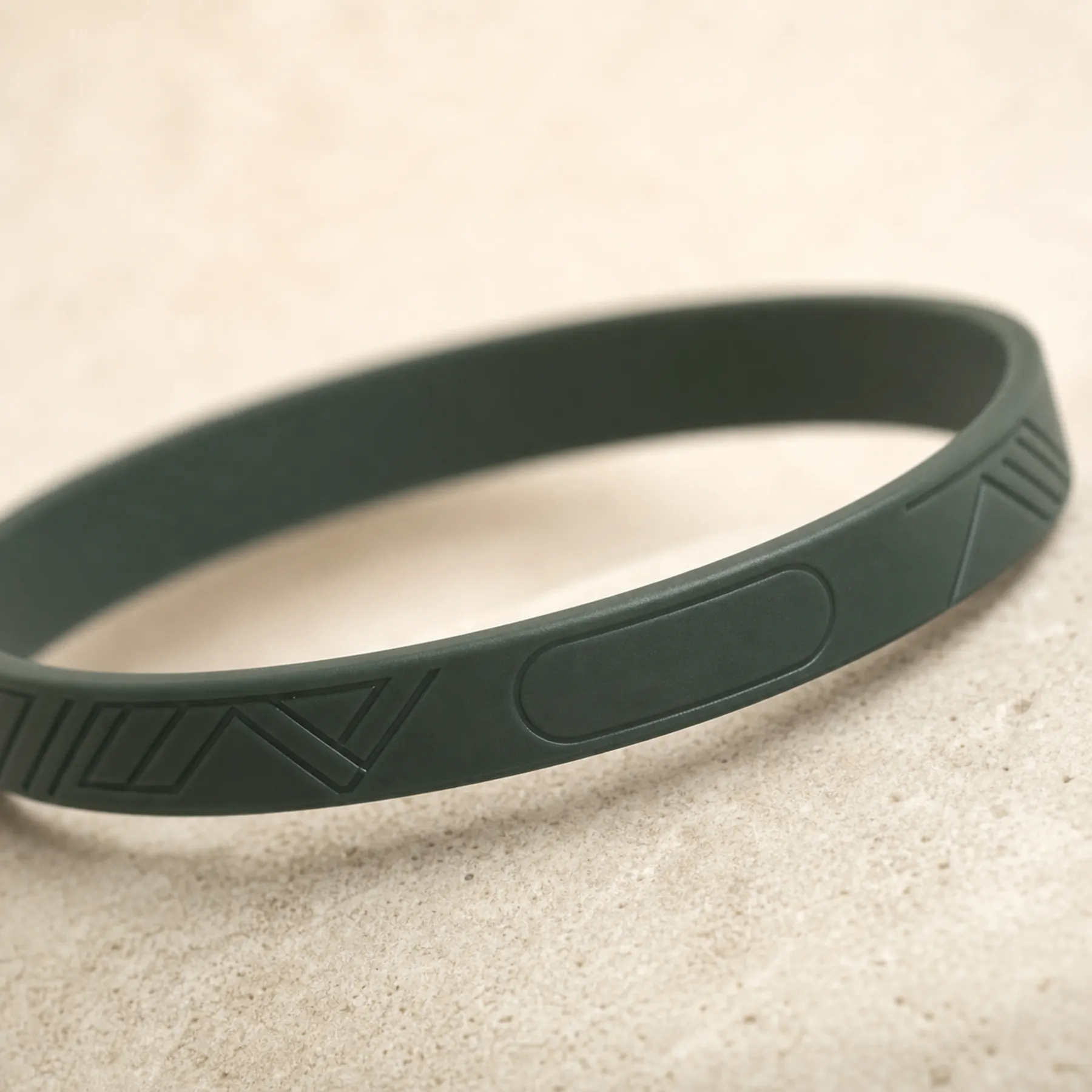 Close view of a compact sealed RFID module molded into a silicone wristband